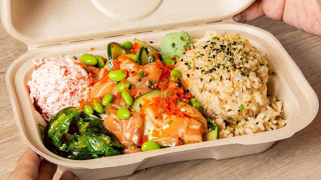 The Classic Salmon Box · Salmon with Spicy Ponzu and Wasabi Citrus sauce, mixed with cucumber, green onion, white onion, and topped with sesame seeds, furikake, wasabi, pickled ginger, and edamame beans. Served with brown rice, crab salad, and seaweed salad.
