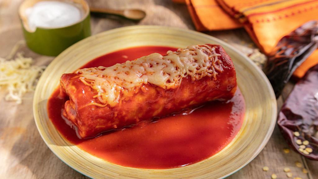 Burrito Mojado · Super Burrito topped with Arteaga’s Enchilada Sauce and melted Cheese