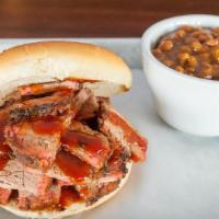 Beef Brisket Sammy · 16-hour pit-smoked Angus beef brisket, sliced and piled high with a dash of honey BBQ sauce.