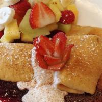 Blintz · Crepes filled with cheese served with blueberry or apple sauce, served with fruit