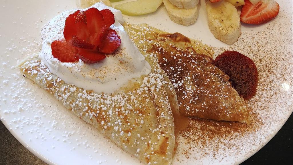 Swedish Pancakes · Crepes with blueberry and apple sauce topped with crème fraise, served with fruit
