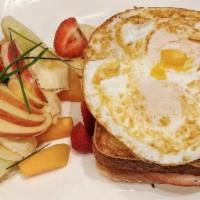 Croque Madame · Grilled ham and cheese on French toast sandwich topped with over easy eggs