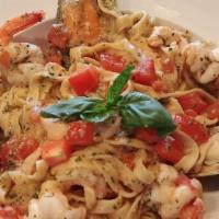 Seafood Sautéed Fettucini · Green mussels, scallop, prawns and salmon with tomato, herbs and white wine sauce