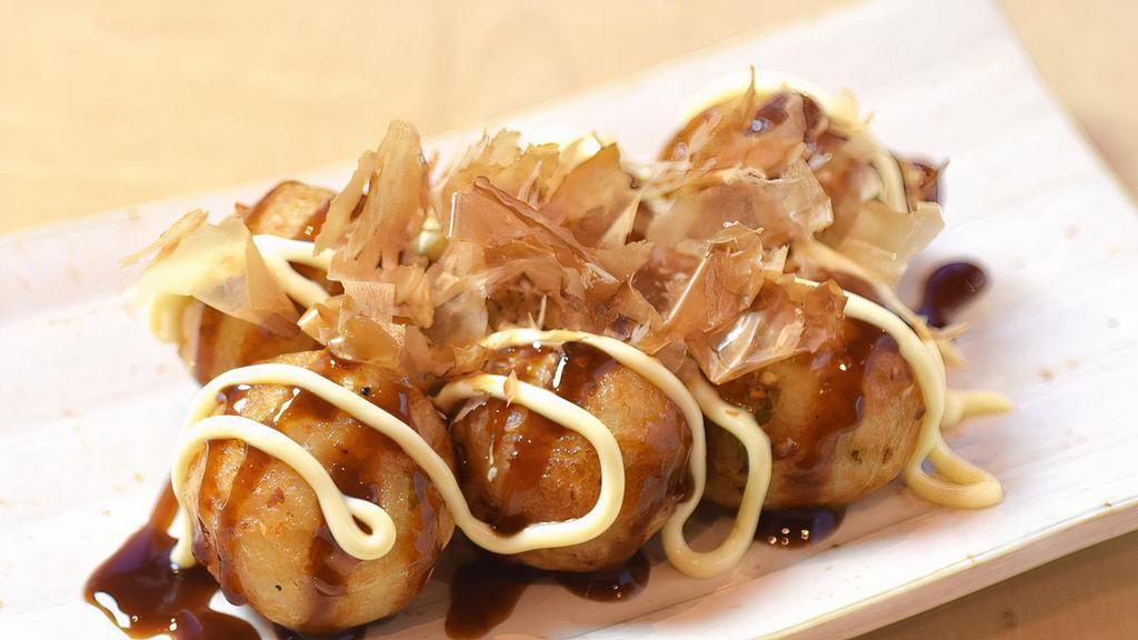 1405. Takoyaki · Fried octopus dough balls topped with Ton Katsu sauce, mayonnaise and bonito flakes