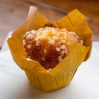 Lemon Muffin · Made with lemon puree and fresh lemon bits finished with pearl sugar topping