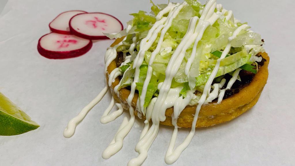 Sopes
 · Homemade thick tortilla, refried beans, lettuce, sour cream, cheese, and green salsa.