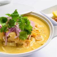 (C) Ohnoh Kawt Swe (Coconut Noodle Soup) · A rich and creamy coconut bisque with flour noodles. Served with chicken, onion, tamarind po...