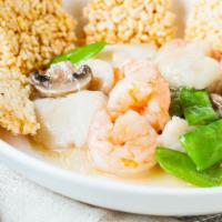 Sizzling Rice Seafood · Shrimp, scallops and white fish braised with tomatoes, button mushrooms, snow peas and bambo...