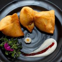 Veg Samosa (2 pcs) · Crispy vegetable turnovers with flavored potato and peas filling, served with chutneys. Alle...
