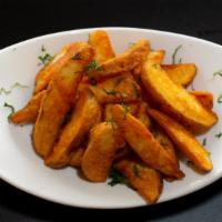 Masala Wedges · Marinated sliced potato wedges with peel, fired and sprinkled with Indian spices