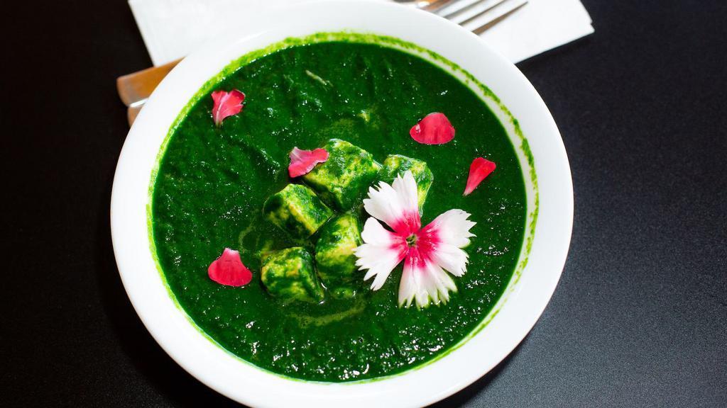 Palak Paneer Curry · Indian cottage cheese cubes cooked in pureed spinach gravy with herbs and spices. You can request Potato or Garbanzo beans to replace Paneer if you want Vegan Option.