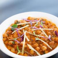 Chana Masala Curry · Garbanzo Beans cooked with finely chopped tomatoes and onions with Indian spices.