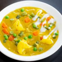 Veg Korma Curry · Assorted Vegetables cooked in a creamy coconut sauce with spices.