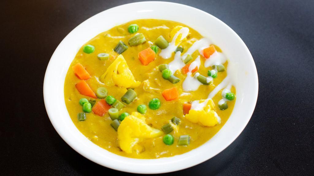 Veg Korma Curry · Assorted Vegetables cooked in a creamy coconut sauce with spices.