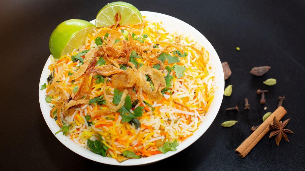 Chicken Biryani · Boneless Chicken pieces marinated, tossed in curry sauce flavored with spices and mixed with flavored basmati rice. Served with raita and salan. Allergy Indicators: Dairy
