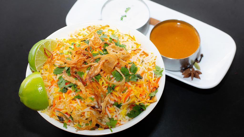 Paneer Biryani · Paneer cubes marinated, tossed in curry sauce flavored with spices and mixed with flavored basmati rice. Served with raita and salan.