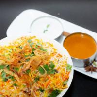 Lamb Biryani · Boneless shoulder lamb pieces cooked curry sauce and mixed with flavored basmati rice. Serve...