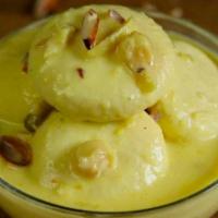 Rasmalai · Soft cottage cheese balls soaked in a rich milk sauce flavored with saffron and pistachio