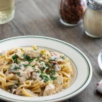 Chicken Fettuccine Alfredo · Sliced chicken breast smothered in our creamy alfredo sauce with fresh mushrooms and red oni...