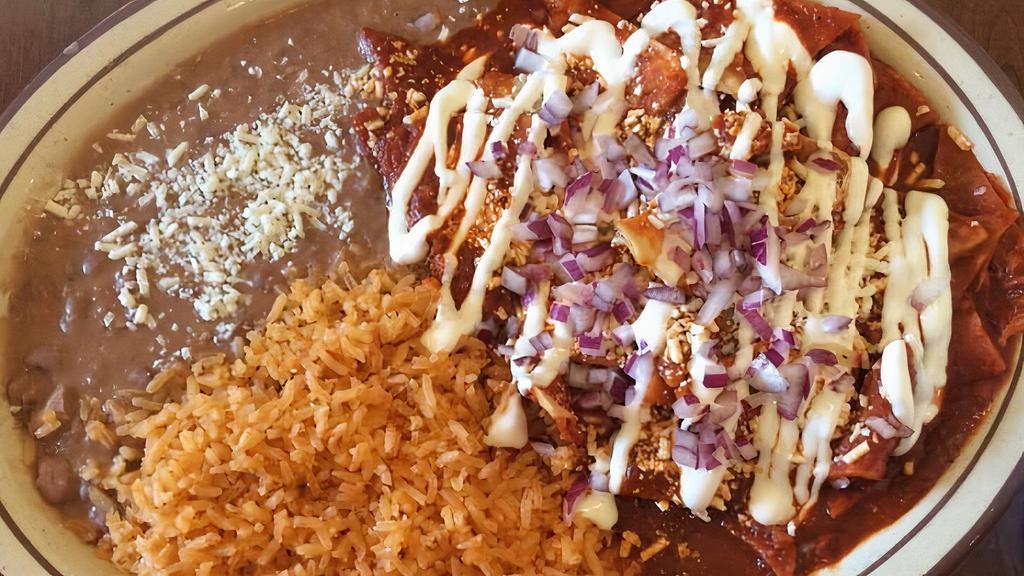 5. Chilaquiles Con Pollo · Tortilla chips cooked with special house sauce, topped with grilled chicken, onion, cheese, sour cream, rice and beans.