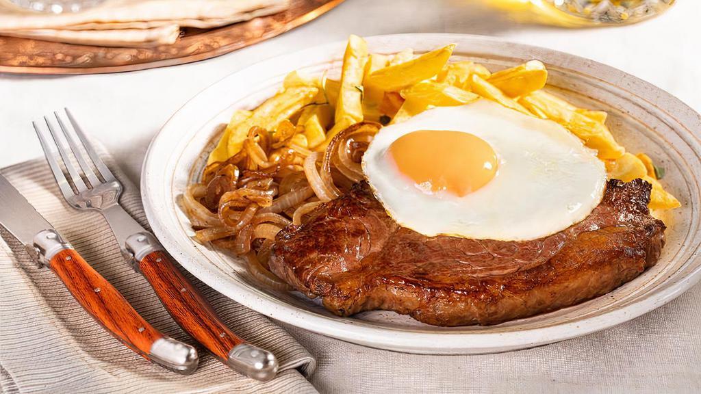 Bife a Cavalo  · (Beef with a fried egg on top) . Served with rice, beans, fries, tomato vinaigrette, and salad.