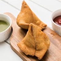 Famous Indian Veg Samosa (2 pcs) · Hot fried pastry shells stuffed with roasted cumin potatoes served with mint and tamarind ch...