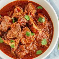 Authentic Lamb Vindaloo · Gluten-free. Fresh chunks of tender lamb and potatoes in smulang hot and sour curry sauce.