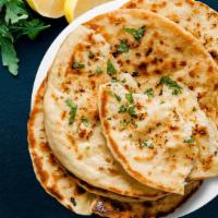 Fire Naan (Chili) · Spicy Flatbread made from white flour flavored with Indian spices and baked in tandoor oven.