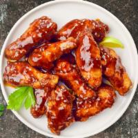 Smoking BBQ Chicken Wings · Fresh chicken wings fried until golden brown, and tossed in barbecue sauce. Served with a si...