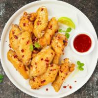 Sawadee Chili Wings · Fresh chicken wings fried until golden brown, and tossed in thai chili sauce. Served with a ...