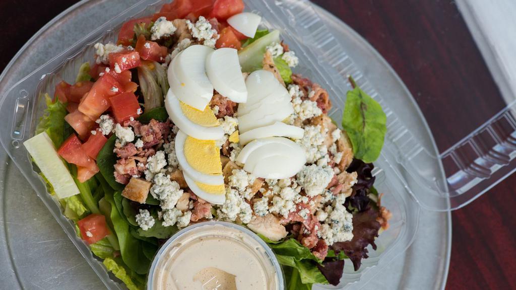 Small The Cobb · Roasted chicken, blue cheese, tomato, chopped egg, bacon and choice of dressing.