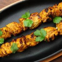 Tandoori Chicken Tikka · 8 Tender pieces of chicken marinated in yogurt, spices, baked in the tandoor and sauteed in ...