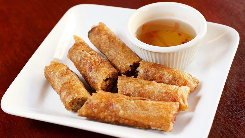 Veggie Crispy Rolls · Crispy wheat flour wrap filled with cabbage, carrots, green beans, vermicelli, mushrooms, tofu, and onions. Vegetarian.