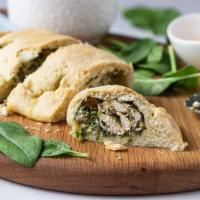 Chicken & Spinach Calzone · Pan baked thick pizza crust layered with grilled chicken, spinach, and mozzarella cheese.