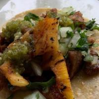 *Al Pastor Taco · Served with pineapple, cilantro & onions