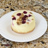 Cranberry Cheesecake (Regular) · Classic vanilla cheesecake accented with orange zest, topped with cranberries and walnuts wi...