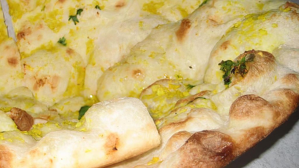 Garlic Naan · Vegetarian. Naan bread stuffed with garlic and herbs.