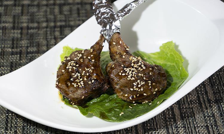 Grilled Lamb Chops · Two grilled lamb chops in barbeque sauce