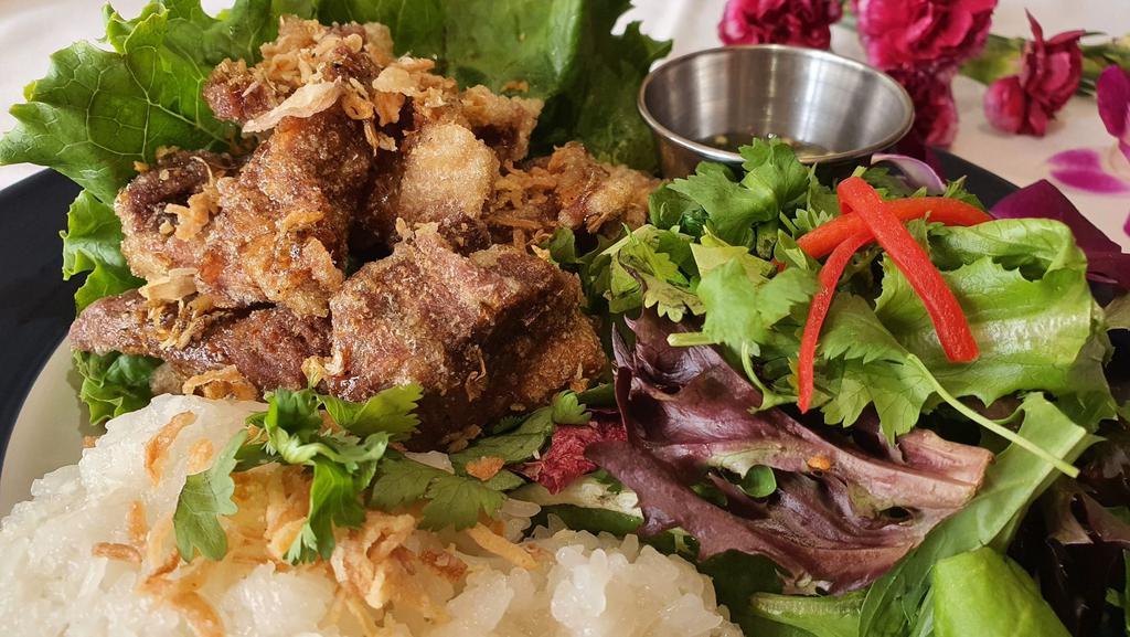 Fried Marinated pork ( Moo – Todd ) · Deep fried Marinated pork with special sauce top with fried onion serve with sticky rice and salad.