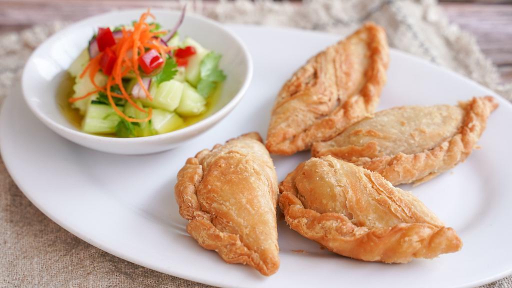 Thai Style Curry Puff · Deep-fried pastry shell with curry, carrots, potatoes, and onions. Choice chicken curry puff or vegetarian curry puff.