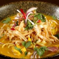 Khao Soi · Northern Thailand dish. Noodles in coconut curry sauce topped with crispy noodle, shallots, ...