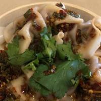 Beef Dumplings · Minced beef, cilantro, carrot, green onion, mushroom served with homemade spicy sauce).