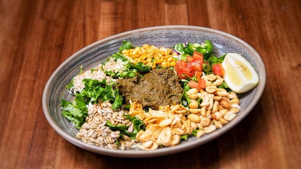 Tea Leaf Salad · Not available without peanut oil. Served with textures from fried garlic, peanuts, sunflower seeds, roasted sesame, lemons, tomatoes, fresh greens, dried shrimp or vegetarian. it's a party in your mouth.