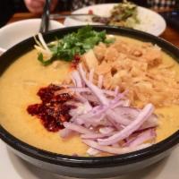 Oh Noh Kauswer Suop · Burmese style coconut noodle soup with chicken. Onions, eggs, cilantro, lemon and chili.
