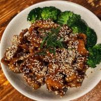 Sesame Chicken · Slices of chicken breast lightly fried in a sweet and tangy sauce topped with sesame seeds.