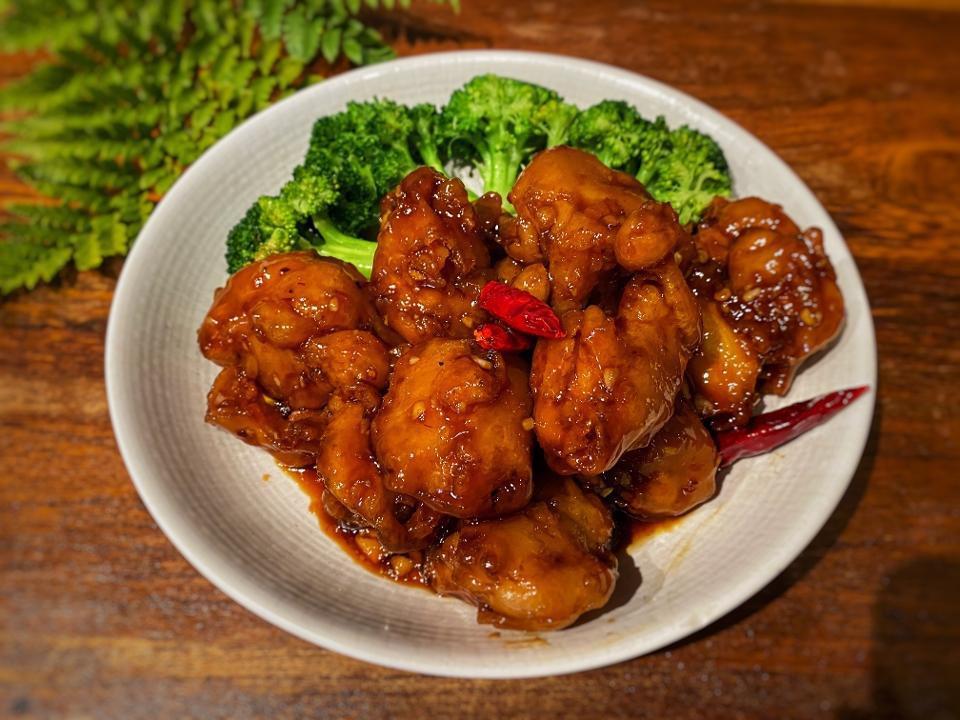 Spicy & Crispy Chicken · Deep fried chicken in a sweet, tangy and spicy sauce with chili and garlic.