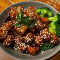Sesame Tofu · Lightly fried tofu cooked with a sweet & tangy sauce, topped with sesame seeds.