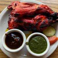 Tandoori Chicken · Two chicken thighs marinated and tandoori-grilled.