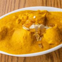 Kofta Mahlai · Vegetable balls in a saffron curry with almond milk, silvered almonds, and raisins.