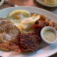 The Abe Lincoln · Three eggs, three silver dollar pancakes, bacon and sausage, potatoes with country gravy. 